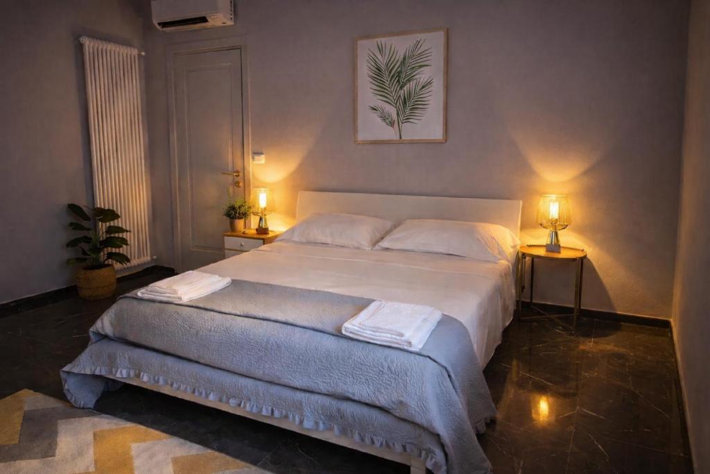 a bedroom with a large bed with two lamps at Casa Cavour in Montecatini Terme