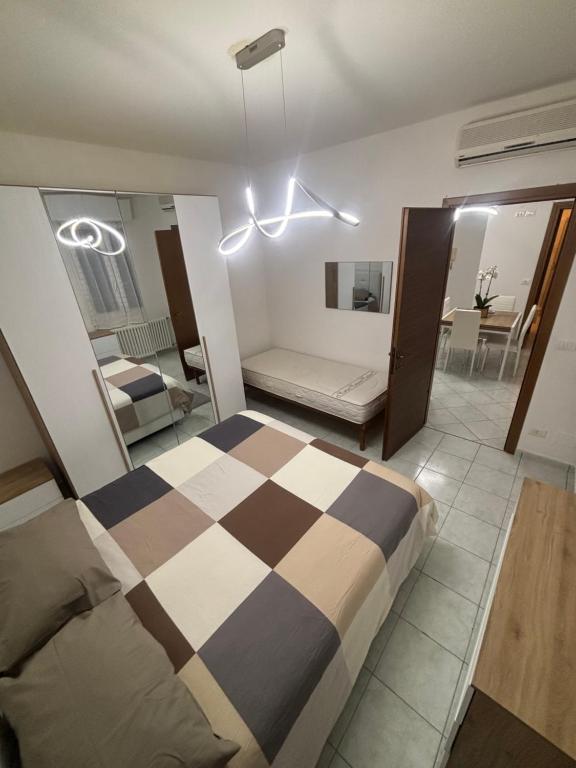 a bedroom with a large bed and a living room at White Nest in Lignano Sabbiadoro