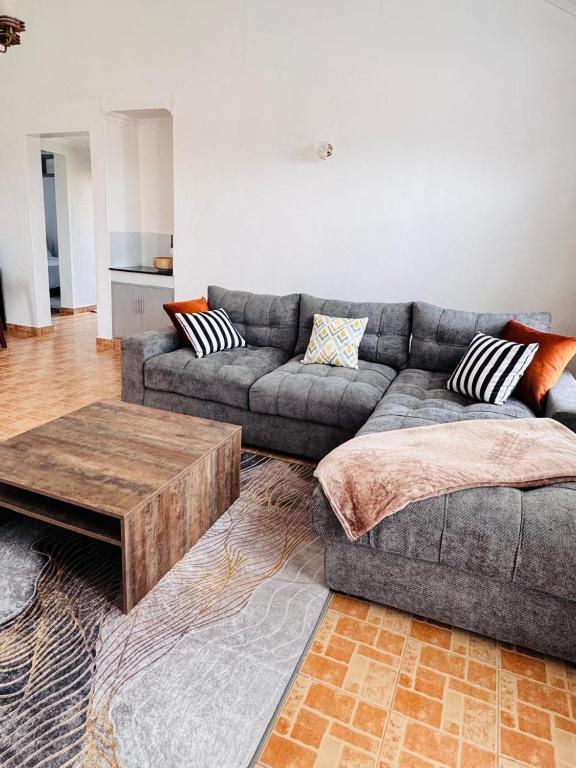 a living room with a couch and a coffee table at Bleu Haven in Kitale