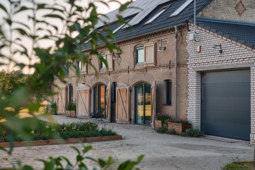 a brick house with its garage doors open at Stodola Rybojady in Rybojady