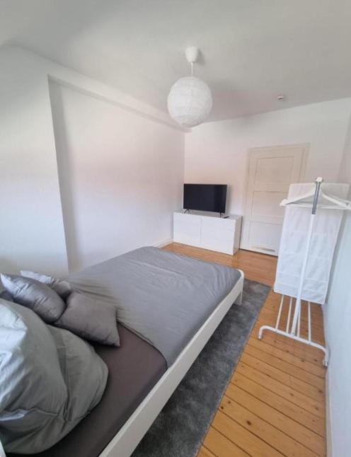 a bedroom with a large bed and a television at Süße Marie 6 in Karlsruhe