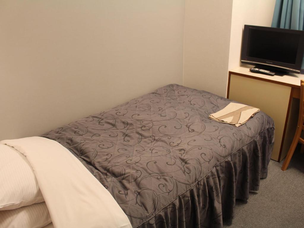 Postel nebo postele na pokoji v ubytování Hotel Trend Funabashi