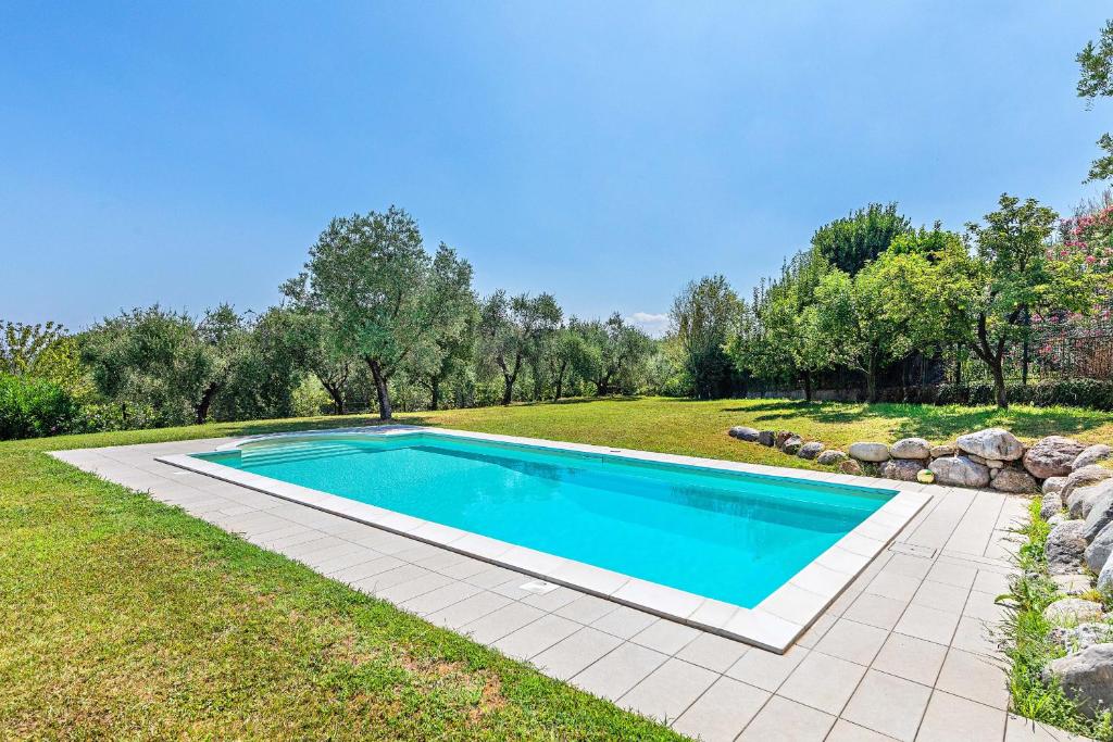 a swimming pool in the middle of a yard at Villa Elisa by Whale Homes in Padenghe sul Garda
