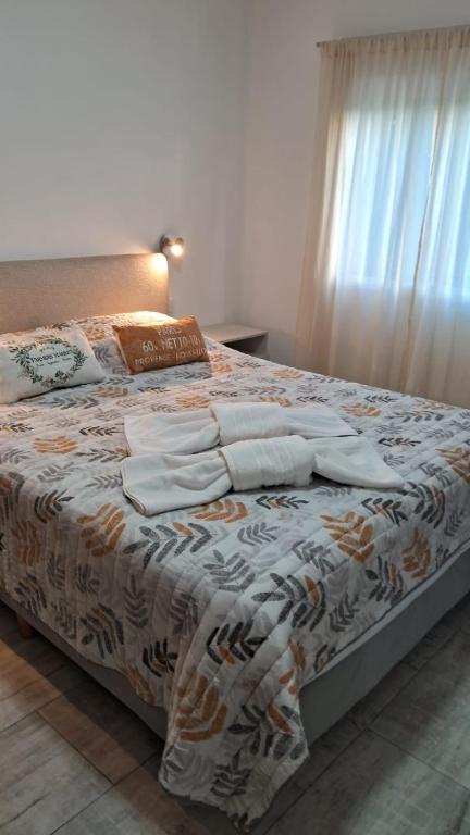 a bedroom with a large bed with pillows on it at Departamento Tunuyan in Monte Hermoso
