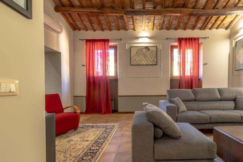 a living room with red curtains and a couch at Altobelli Apartment in Rieti