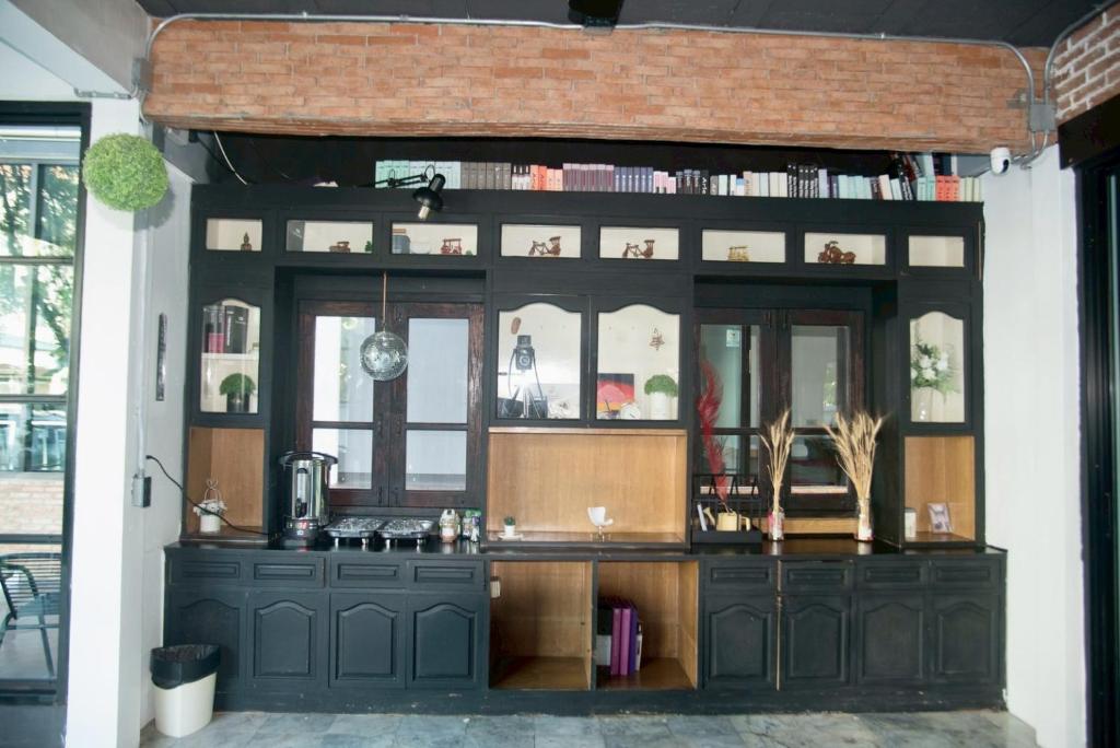 A compact breakfast or refreshment station built into a black cabinet wall.