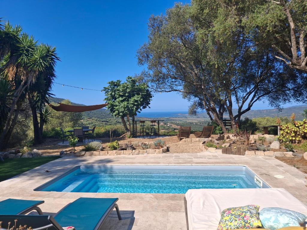 a swimming pool with a view of the ocean at A Casa Faggia in Sollacaro