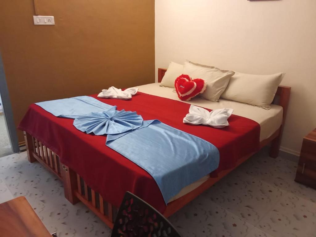 two beds in a hotel room with towels on them at Moonlight Residency in Kollam