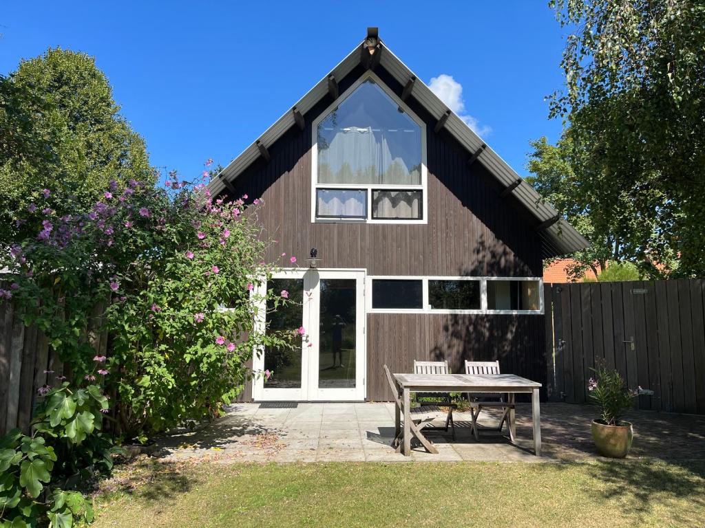 a house with a picnic table in front of it at De Tuinkamer in Ouddorp