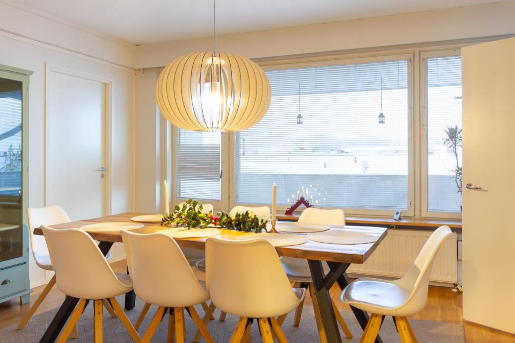 a dining room with a table and chairs at Aurora Family Suite in Rovaniemi