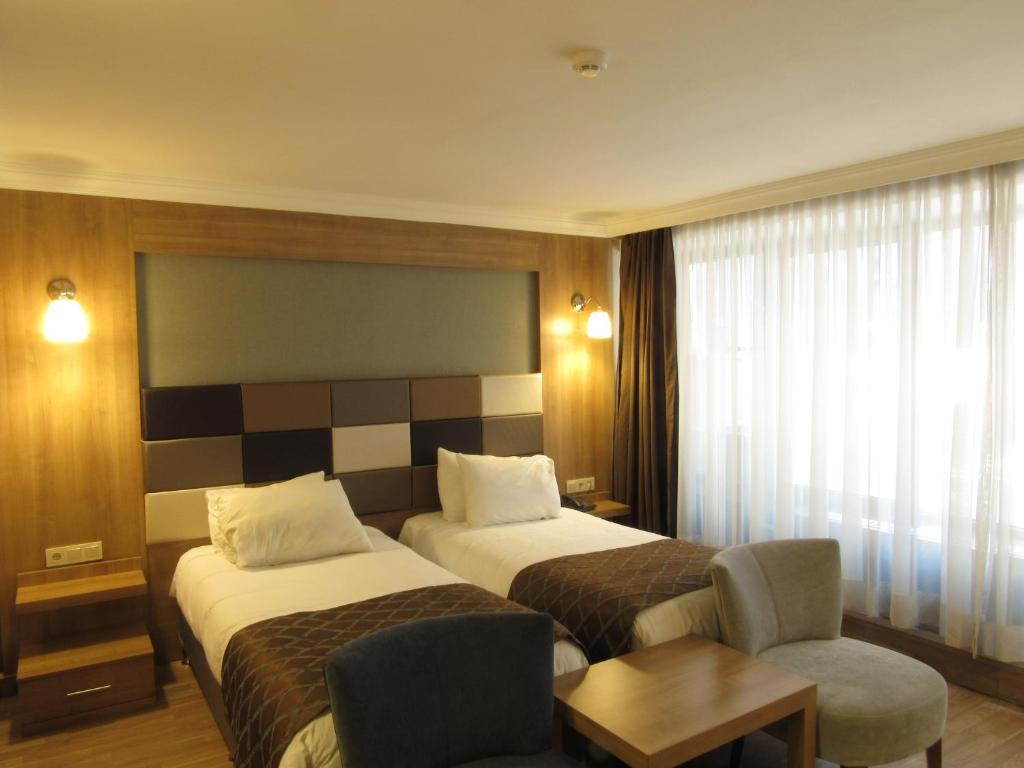 Postel nebo postele na pokoji v ubytování Kadikoy Park Suites