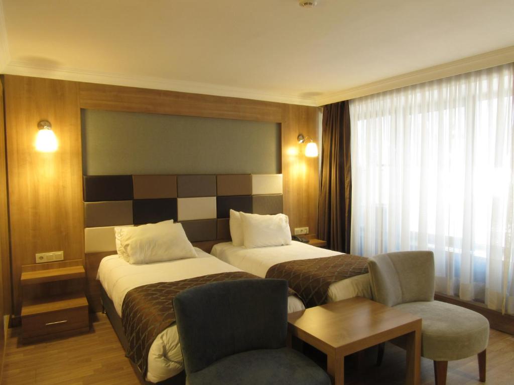 Postel nebo postele na pokoji v ubytování Kadikoy Park Suites