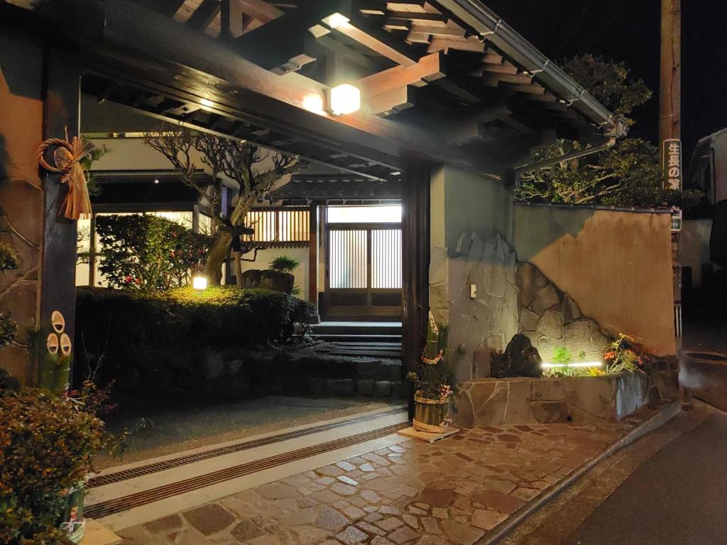 a building with a stone fireplace in a courtyard at night at 山海温泉別荘Hot Spring Villa in Beppu