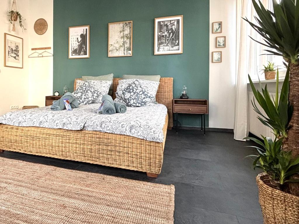 a bedroom with a wicker bed and a green wall at COZEE - The Oasis in Kaiserslautern