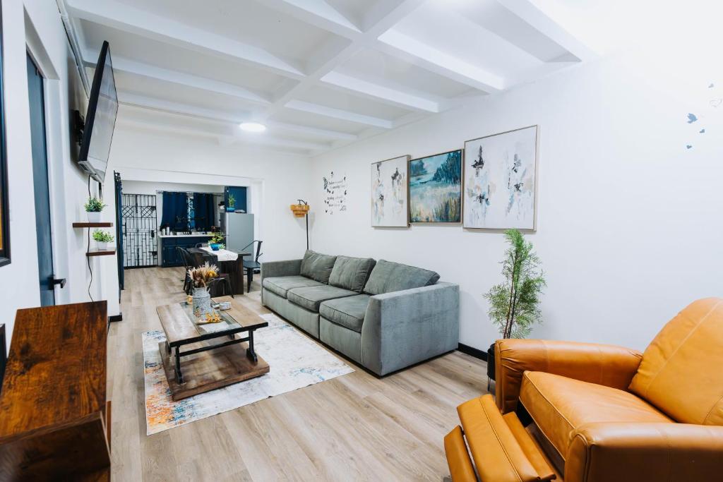 a living room with a couch and a table at Aintree Bungalow in Portmore