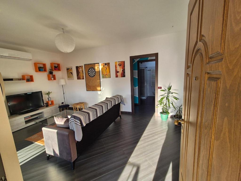 a living room with a couch and a tv at Casa Scova, entire apartment in Garlasco