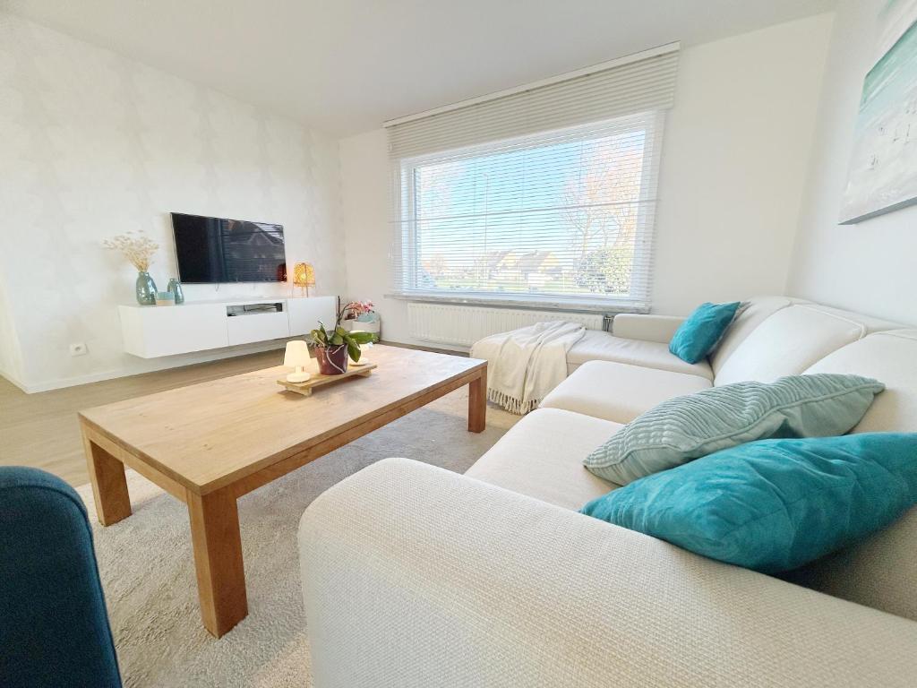 a living room with two couches and a coffee table at Villa Duin 33 in Westende