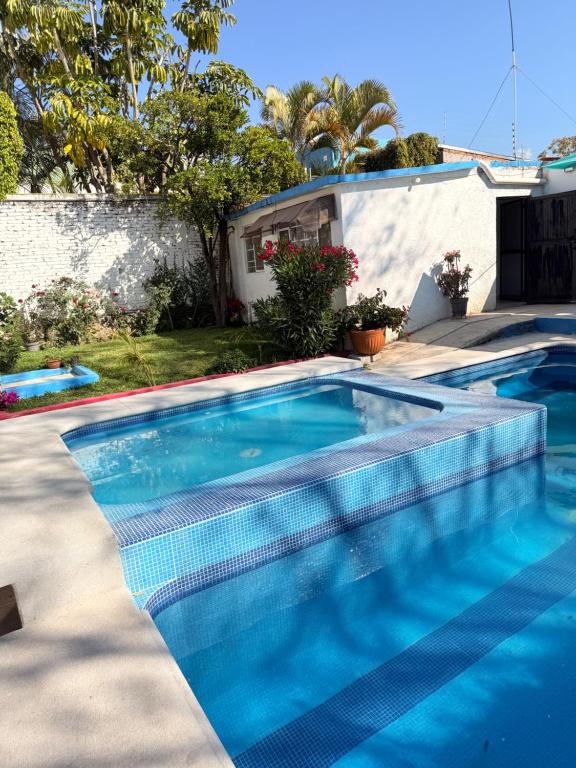 a swimming pool in front of a house at Casa en Cuernavaca Morelos in Cuernavaca