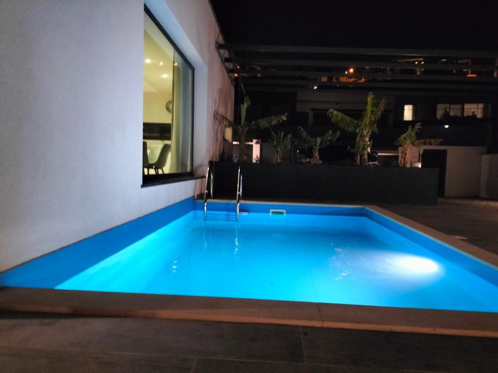 a swimming pool in the middle of a building at night at Villa Atlantic Lodjadis in Gaula