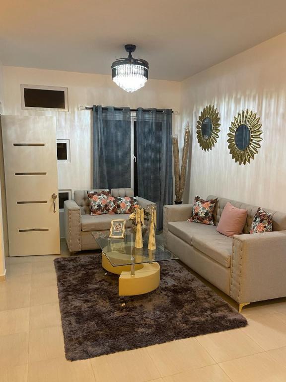 a living room with two couches and a glass table at Byk in Nagua