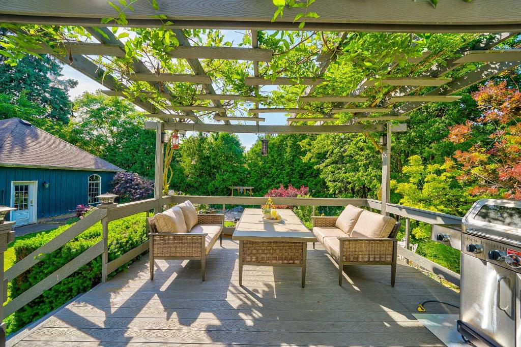 a patio with a table and chairs under a pergola at Charlotte Garden Bed and Breakfast in Niagara on the Lake