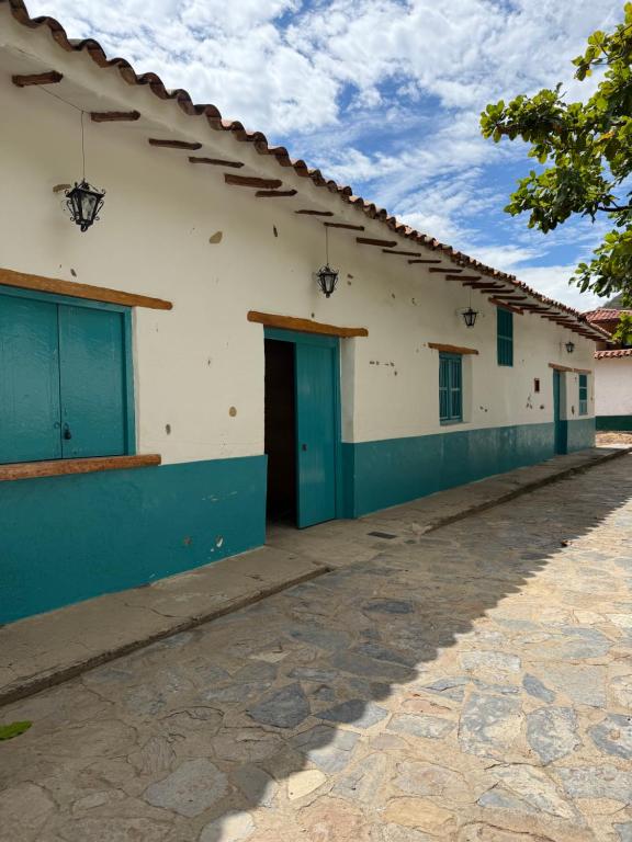 a building with blue doors on the side of it at Posada Los Tres Arrieros in Jordán