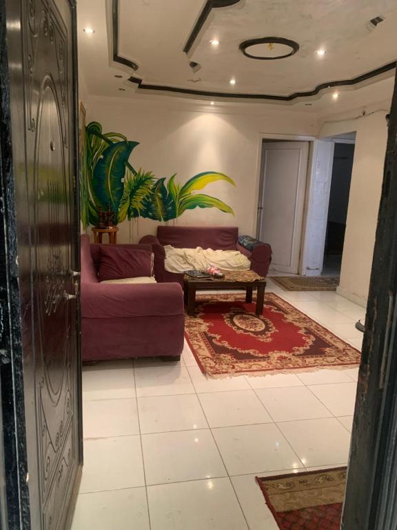 a living room with a couch and a table at Simple gem in port said in Port Said