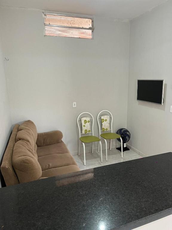 a living room with a couch and two chairs at Casa in São Raimundo Nonato