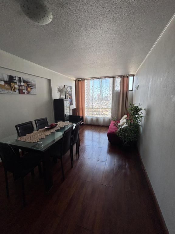 a living room with a dining room table and chairs at Campanario 104 in Iquique