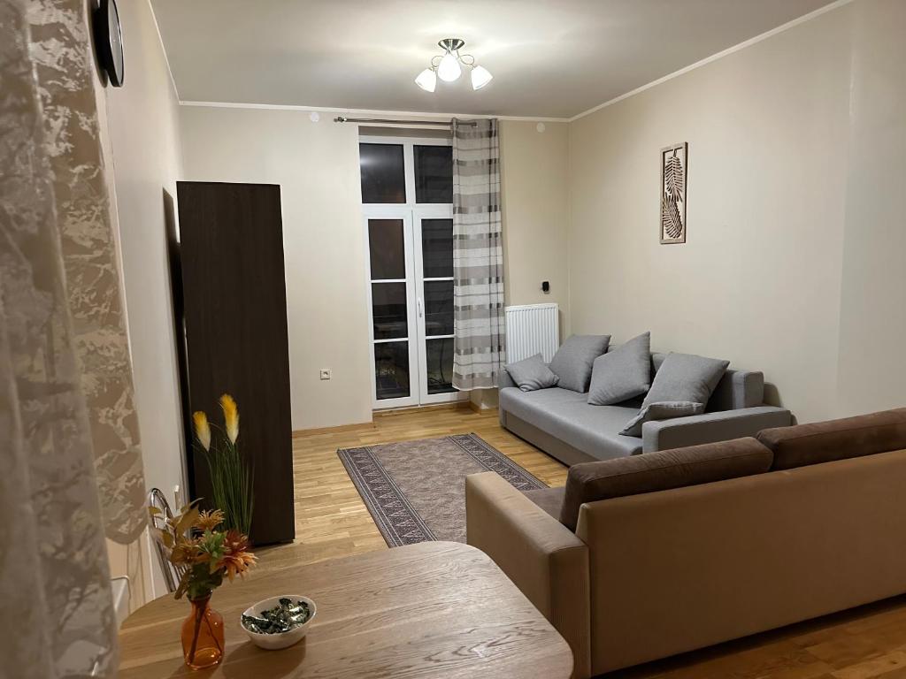 a living room with a couch and a table at SUNNY holidays in Liepāja