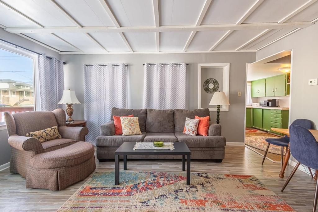 a living room with a couch and a table at Rustic 2 Bedroom Boho Apartment in Laramie