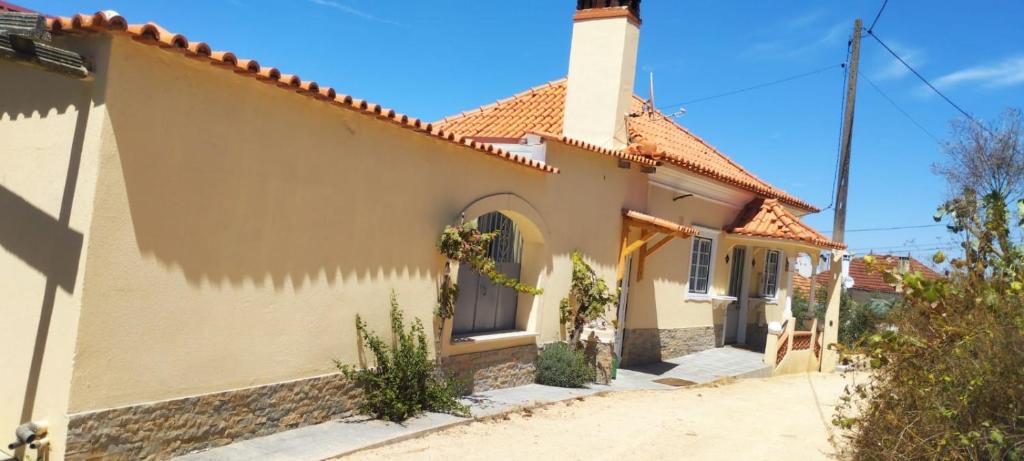 a small white house with a tower at Portela ALR in Portela da Memória