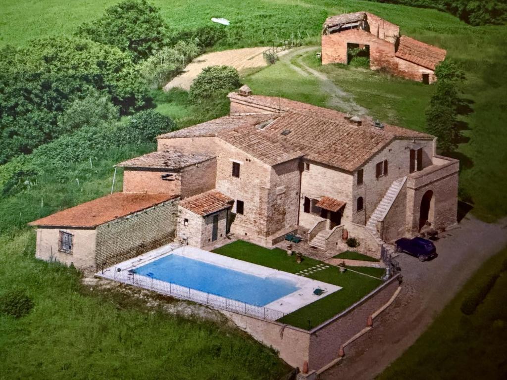 an aerial view of a house with a swimming pool at Podere Stabbia in Rosennano