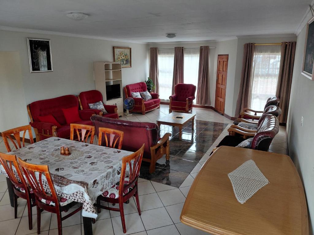 a living room with a table and chairs at VSA SELF CATERING accommodation unit 2 in Newcastle