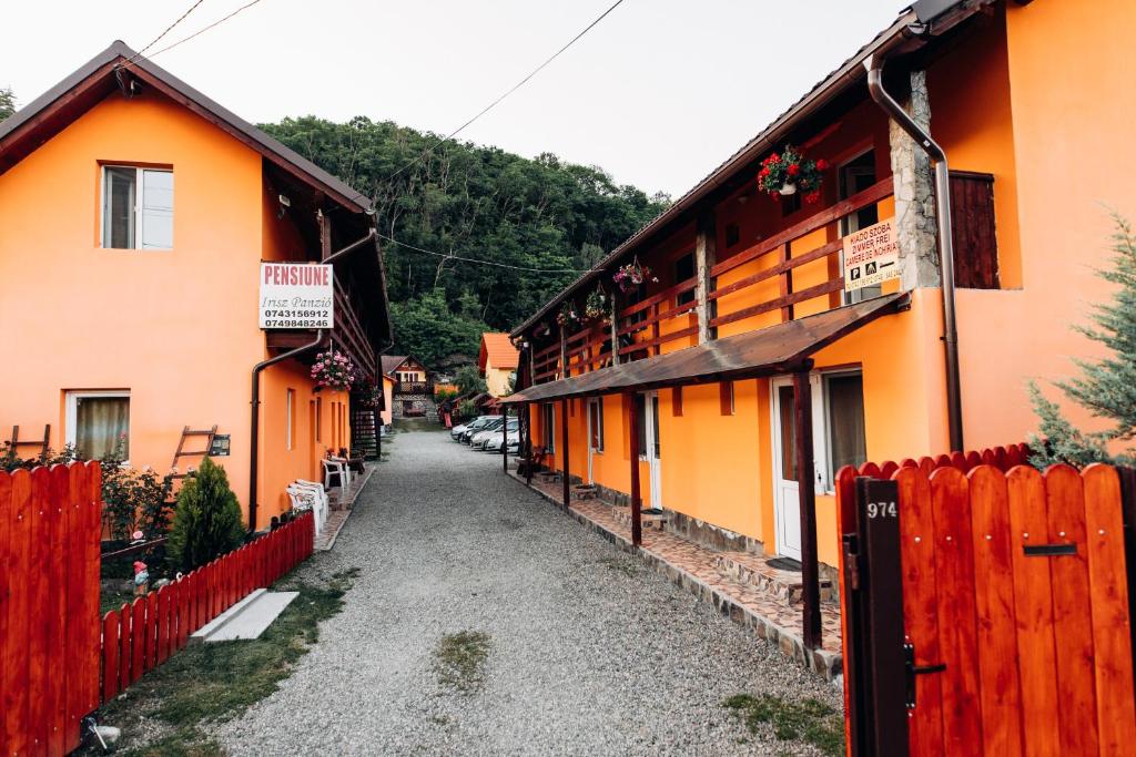 an alley between two buildings with a fence at Iris Panzio in Praid