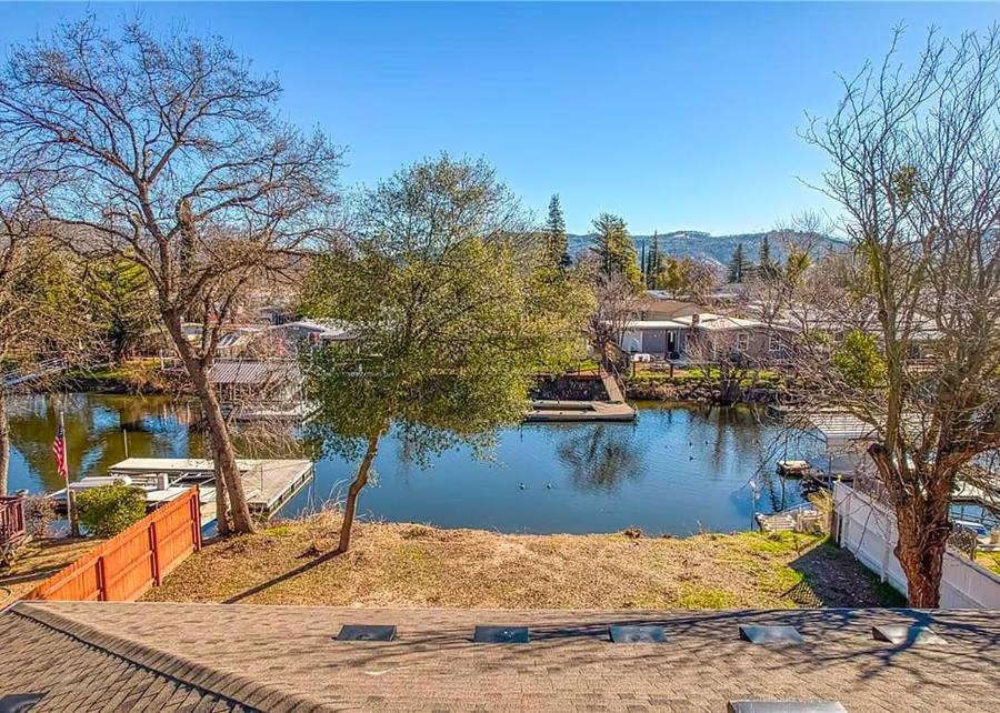 a view of a body of water with trees and houses at Lakefront Retreat • Private Yard + Fireplace in Clearlake Oaks
