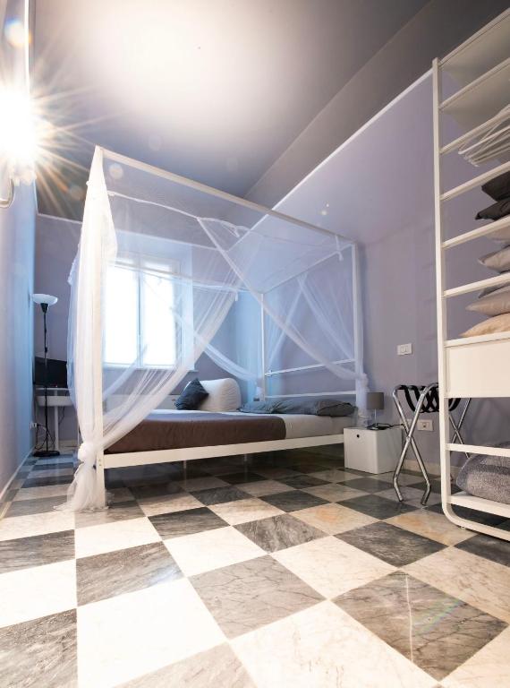 a bedroom with a bed and a checkered floor at Cristina e Elena Suite in Pisa