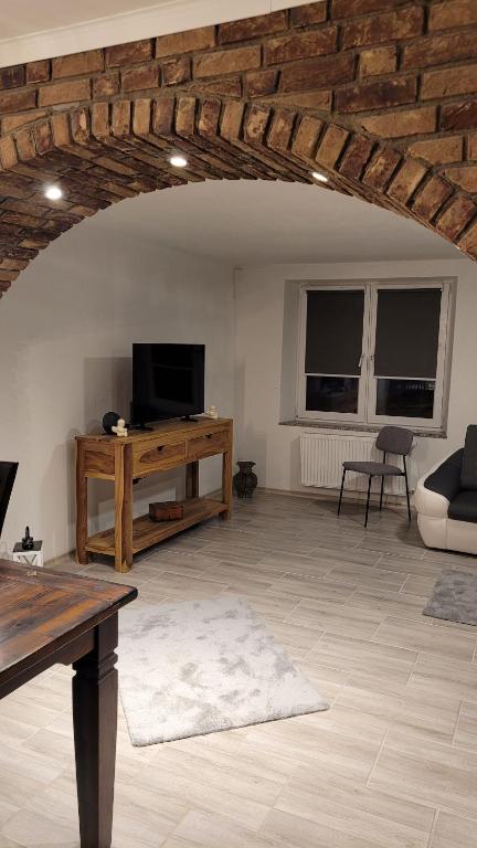 a living room with a tv and a table at Wohnung für 7 Personen in Hückelhoven