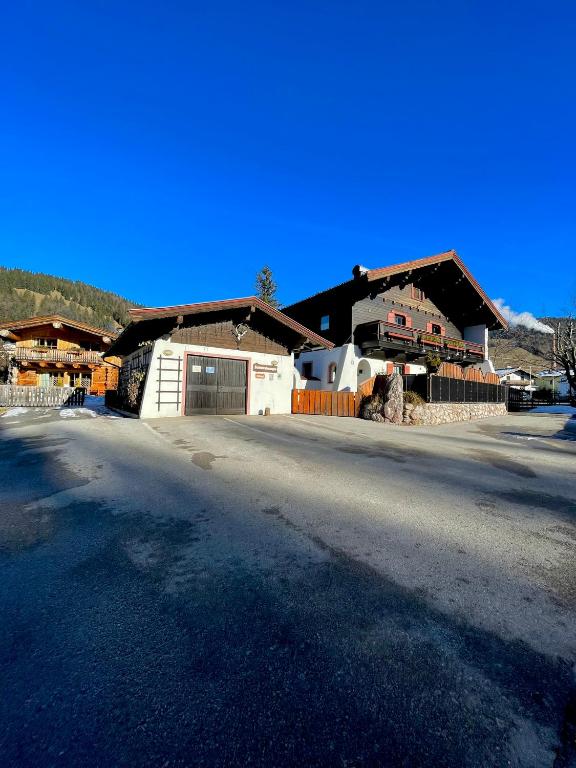 a large house with a driveway in front of it at Gästehaus Katharina in Hochfilzen