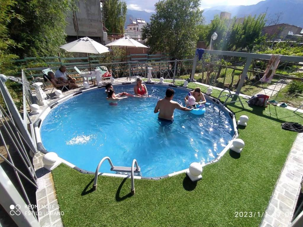 a group of people playing in a swimming pool at Hostería El Zaguan in Cafayate