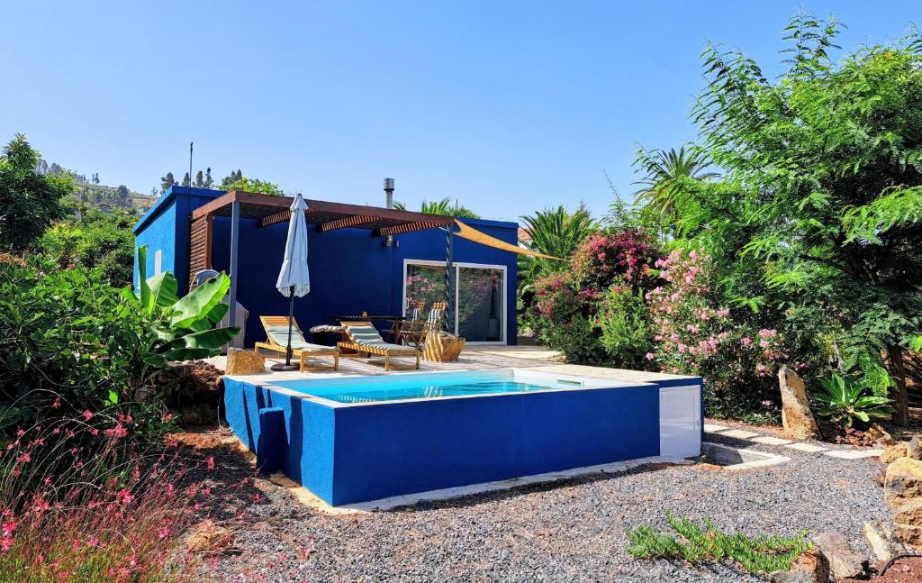 a blue house with a swimming pool in the yard at Casa Nogal in Puntagorda