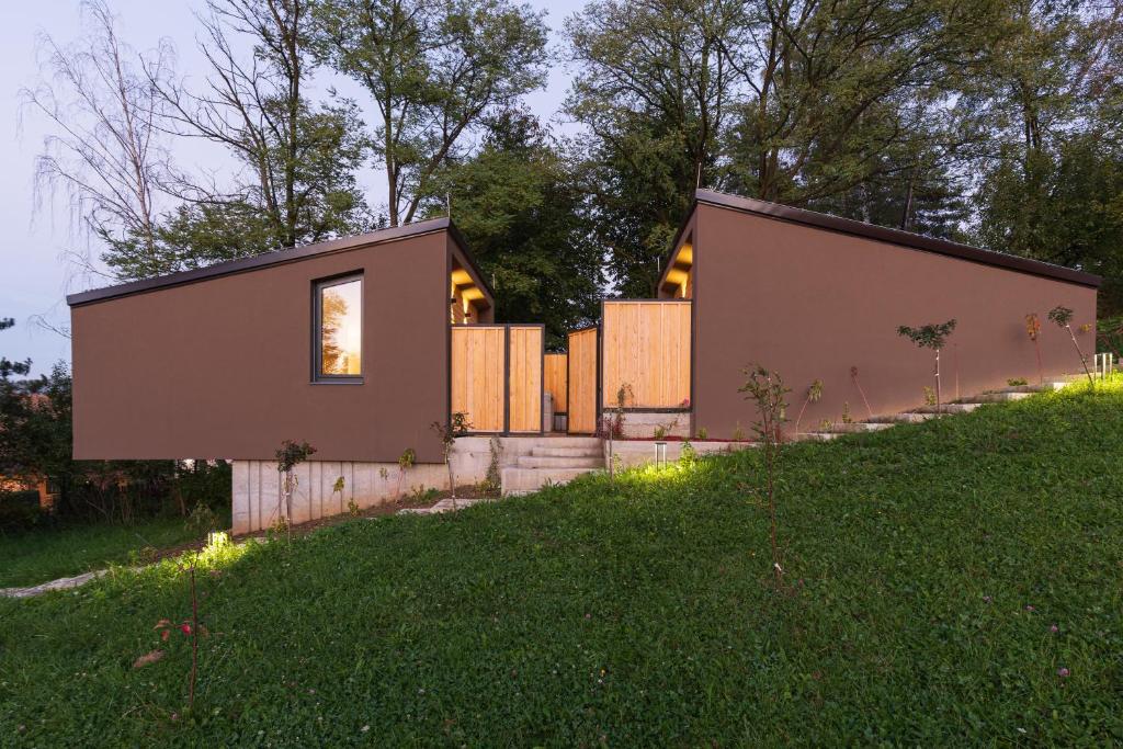a small house on the side of a hill at BLOK Wood Cottage in Visoko