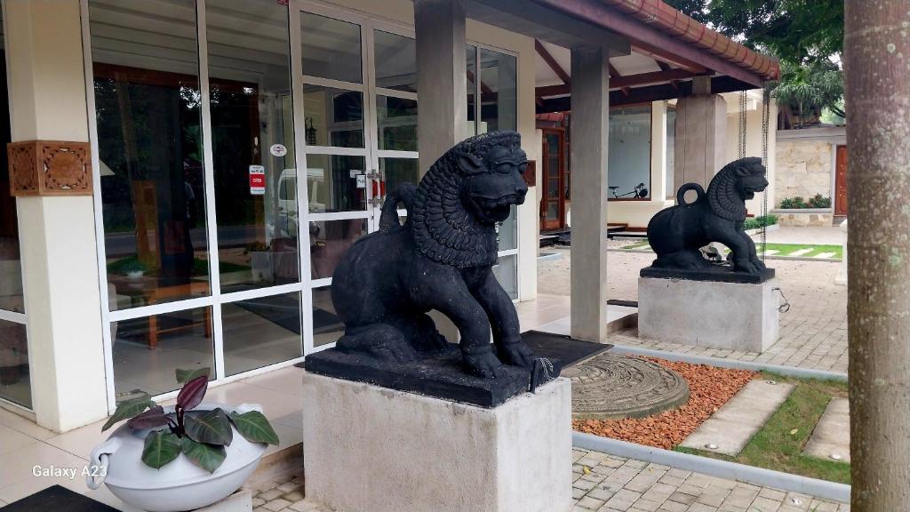 a statue of a lion in front of a building at Sadula Holiday Resort in Anuradhapura