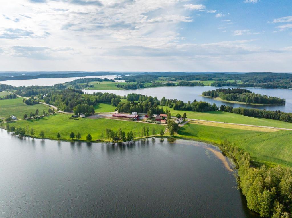 an aerial view of a large body of water with a house at Mökki maaseudulla 