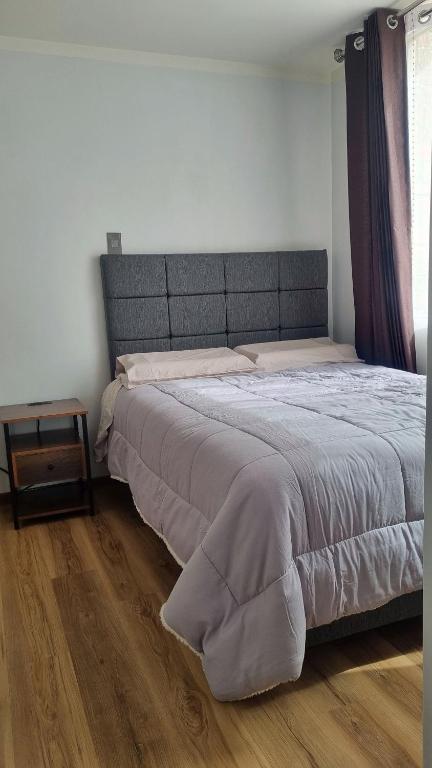 a large bed in a bedroom with a wooden floor at Mirador volcanes in Santa Luisa