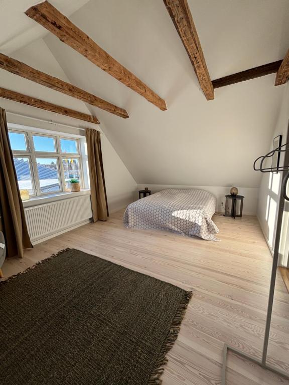 a bedroom with a bed and a large window at Unique Living - Herning City Central House in Herning