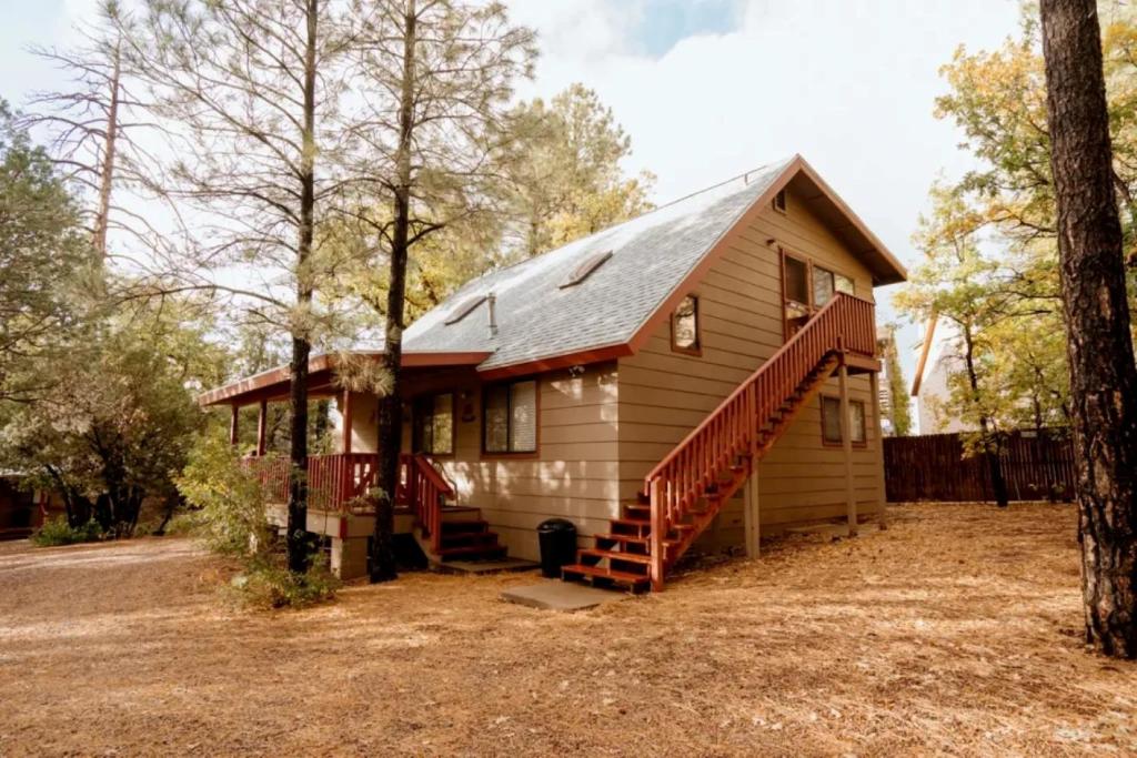 a small house with a red roof at Northwoods Cabins in Pinetop-Lakeside