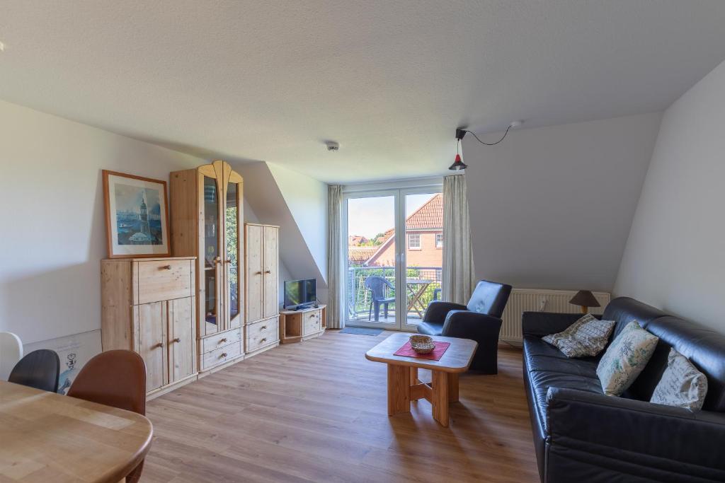 a living room with a couch and a table at Haus Stranddüne, Whg 6 in Cuxhaven