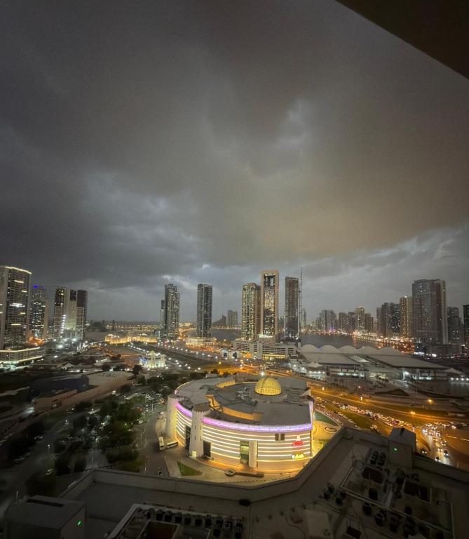 a view of a city at night with buildings at Panoramic Sea apartment & Skyline View Private Room in Sharjah