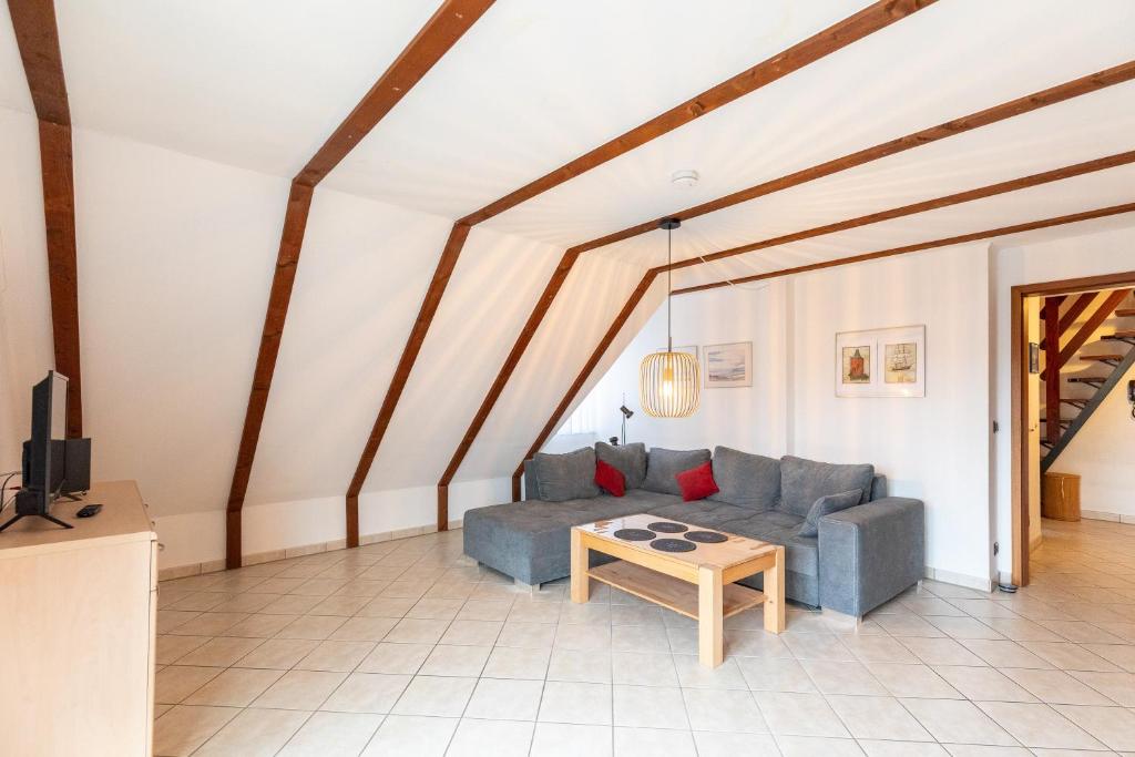 a living room with a couch and a table at Am Grooten Steen, Whg 19 in Duhnen